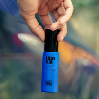 London Flair car air freshener spray by The Scentz Company held inside car interior for fresh citrus inspired long lasting fragrance