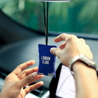 London Flair car beanbag air freshener by The Scentz Company held inside a car delivering long-lasting fragrance