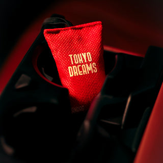 Tokyo Dreams scented car air freshener beanbag by The Scentz Company placed inside car interior offering floral fruity long lasting fragrance